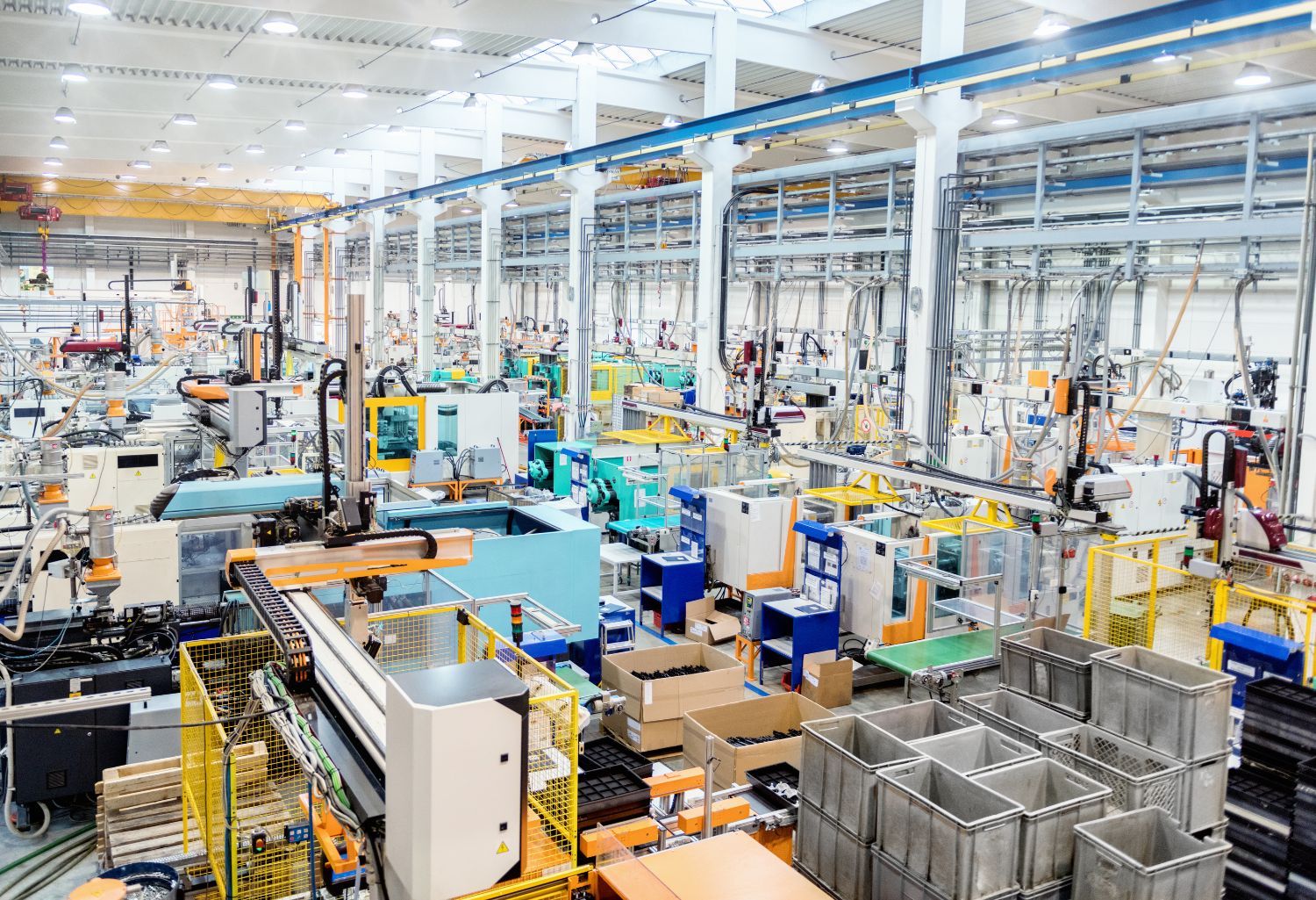 Horizontal color image of modern factory with manufacturing equipment and machinery.